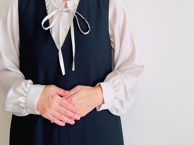 お腹を押さえる女性